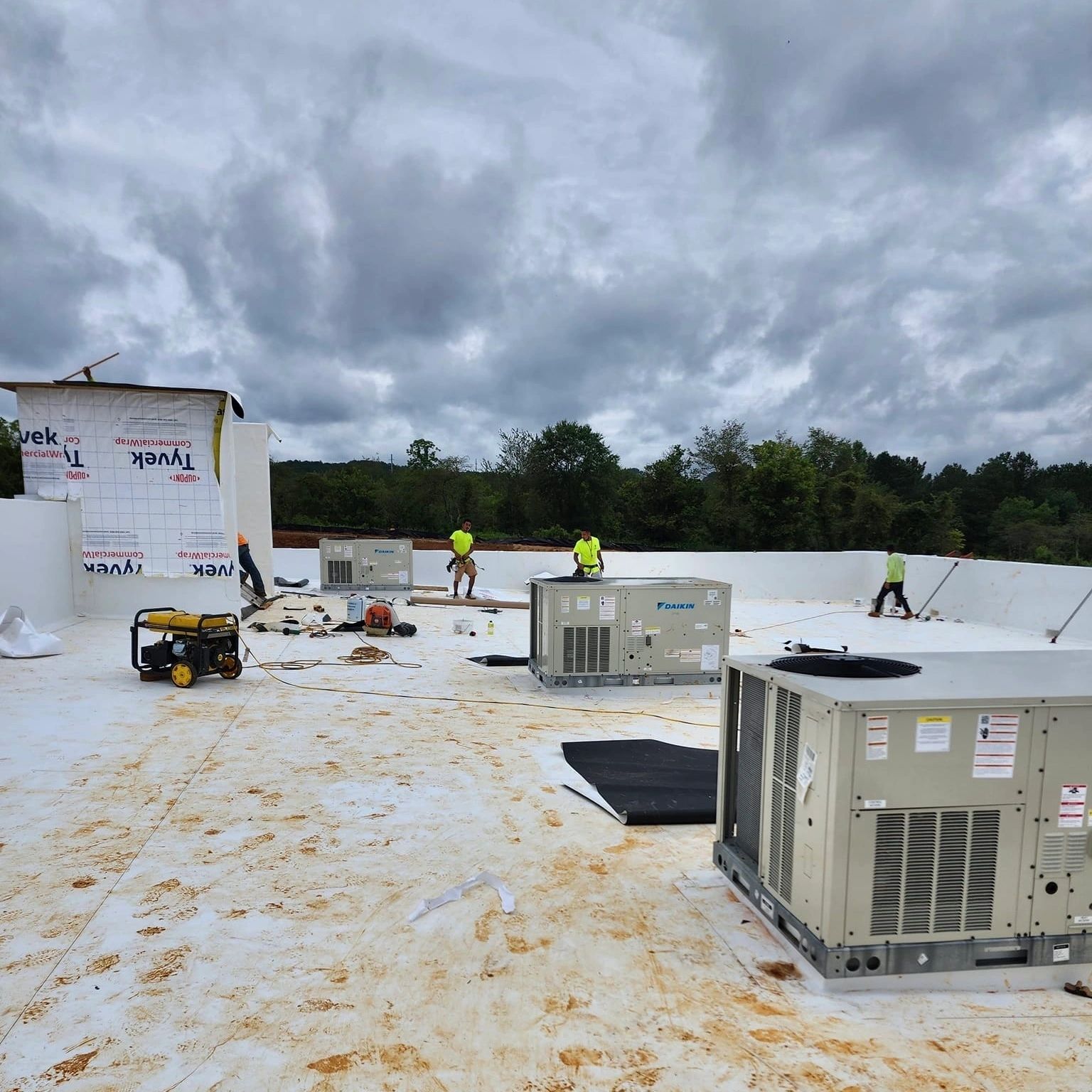 Technicians working on rooftop units
